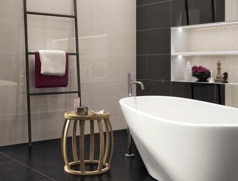 Warm-neutral bathroom renovation with a freestanding tub, timber stool and ladder towel rail